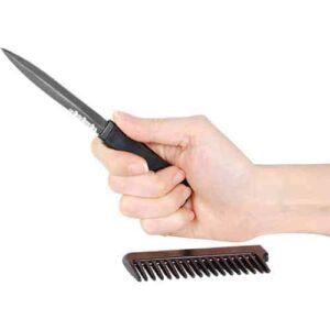 black comb knife open in hand