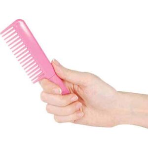 pink comb knife closed in hand
