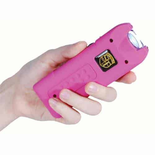 pink multi guard stun gun in hand
