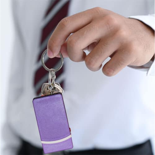 purple keychain stun gun in hand
